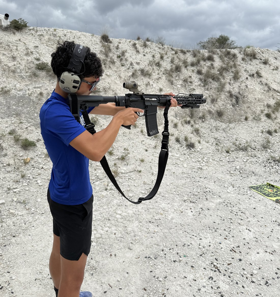 A young shooter running a rifle safely on the line near Del Rio, Texas